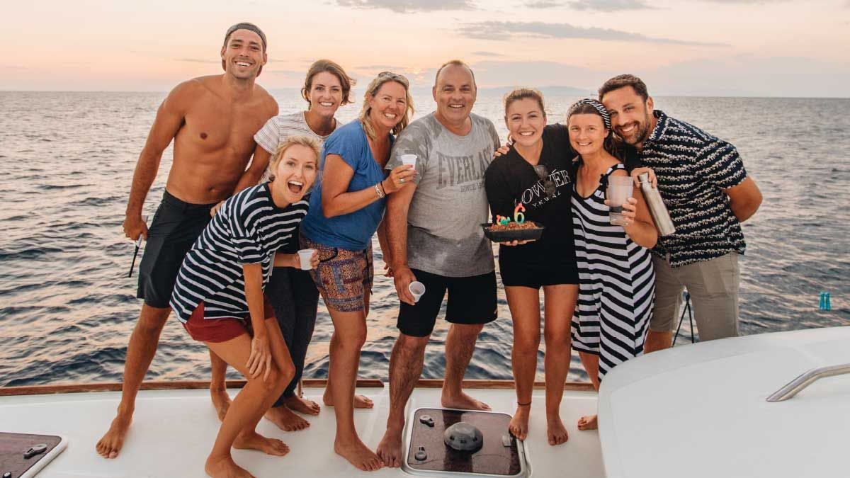Group of Yacht Getaways guests celebrate a birthday onboard