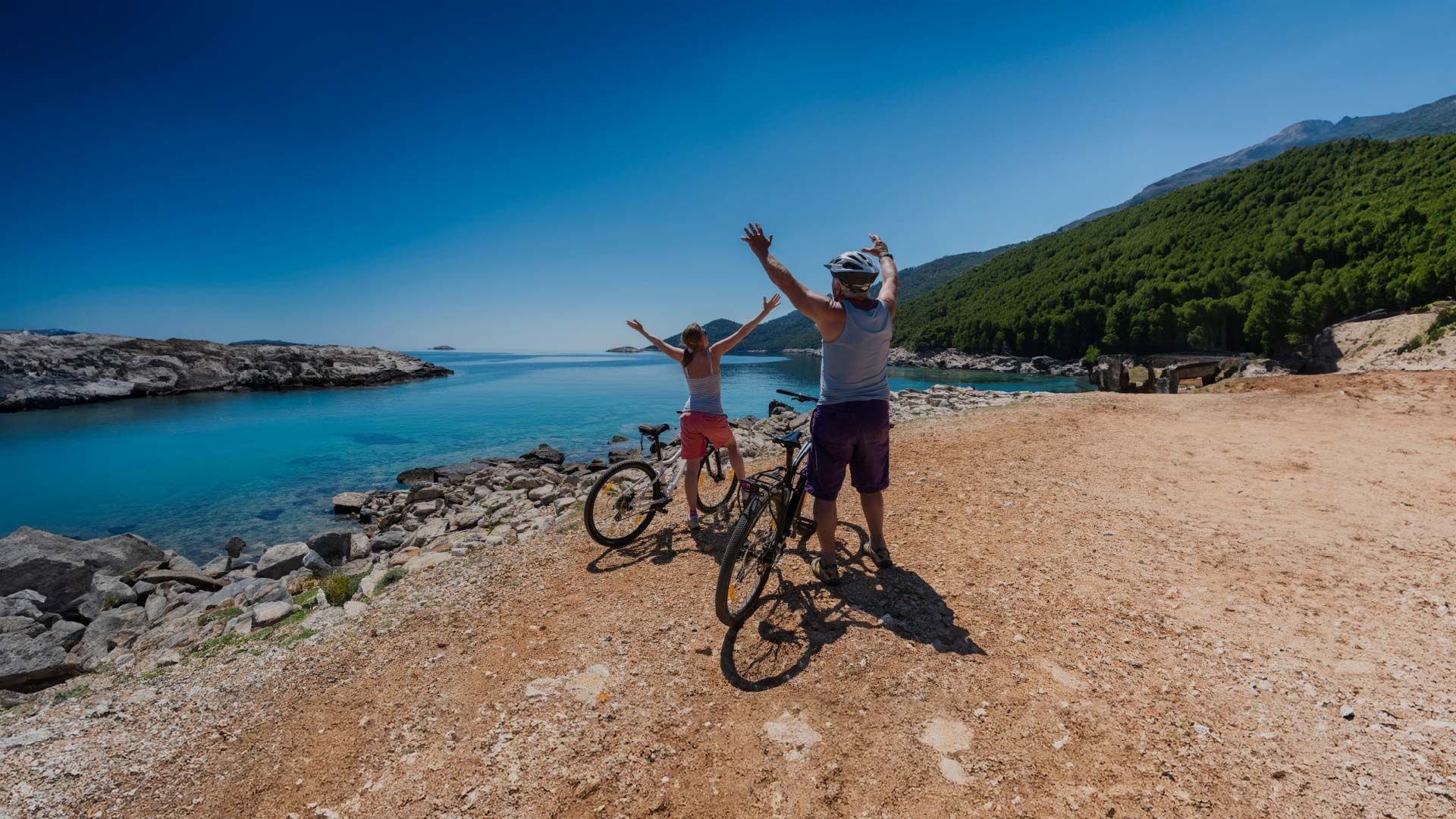 Two people on bikes admire the view in Mljet National Park in Croatia