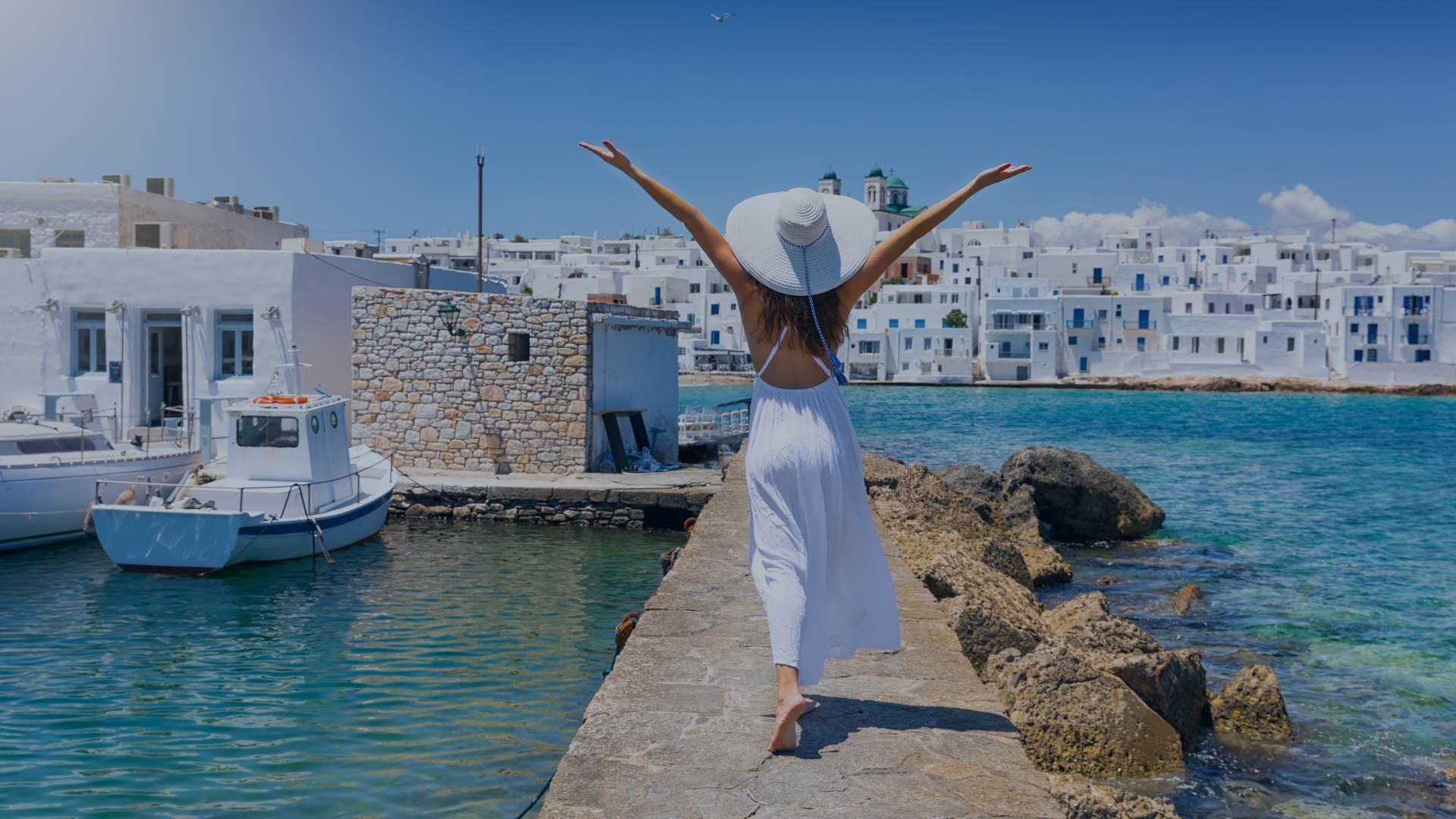 Woman walking on the waterfront in Paros