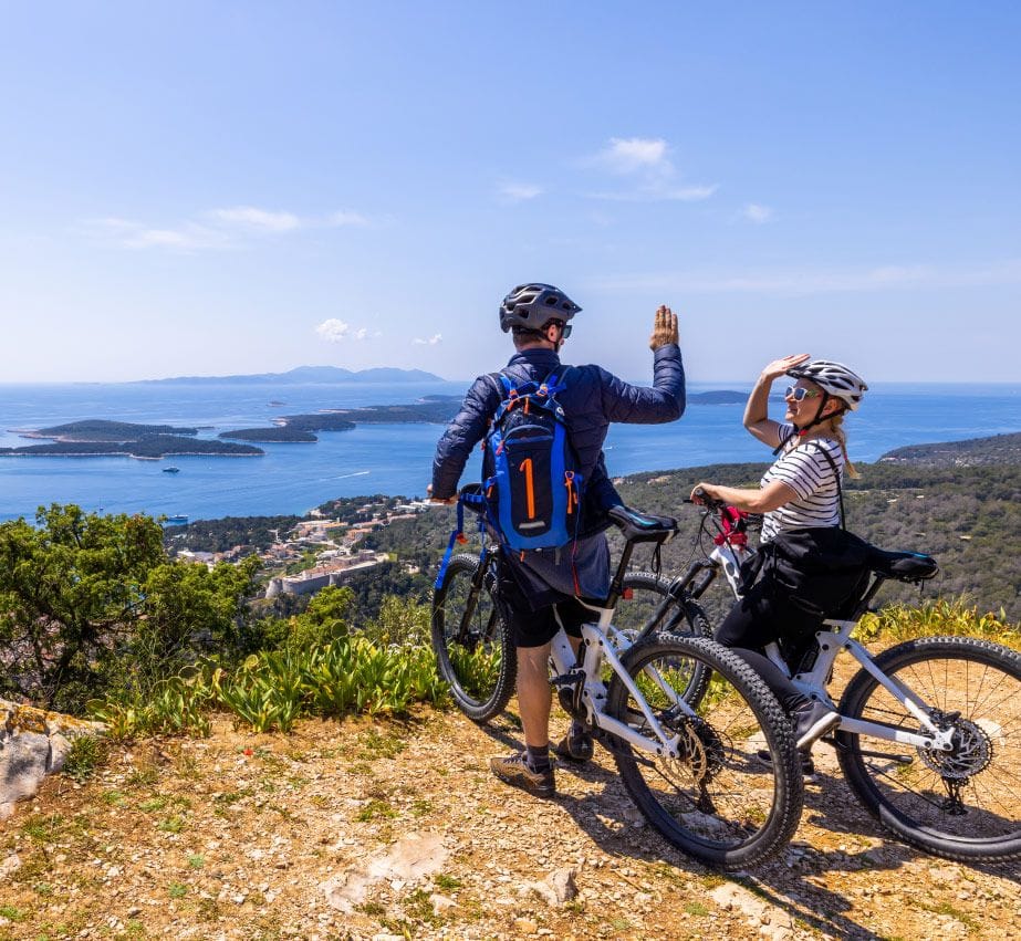 Couple on their bikes high five in Croatia